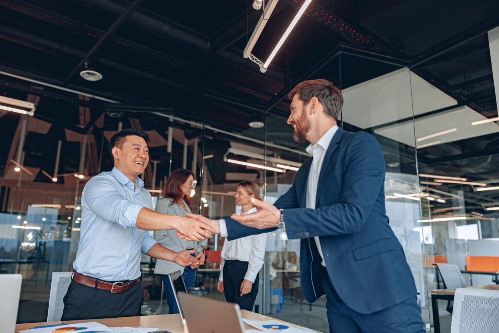 Business leader shaking hands with a client, highlighting successful customer retention strategies built on trust and partnership.