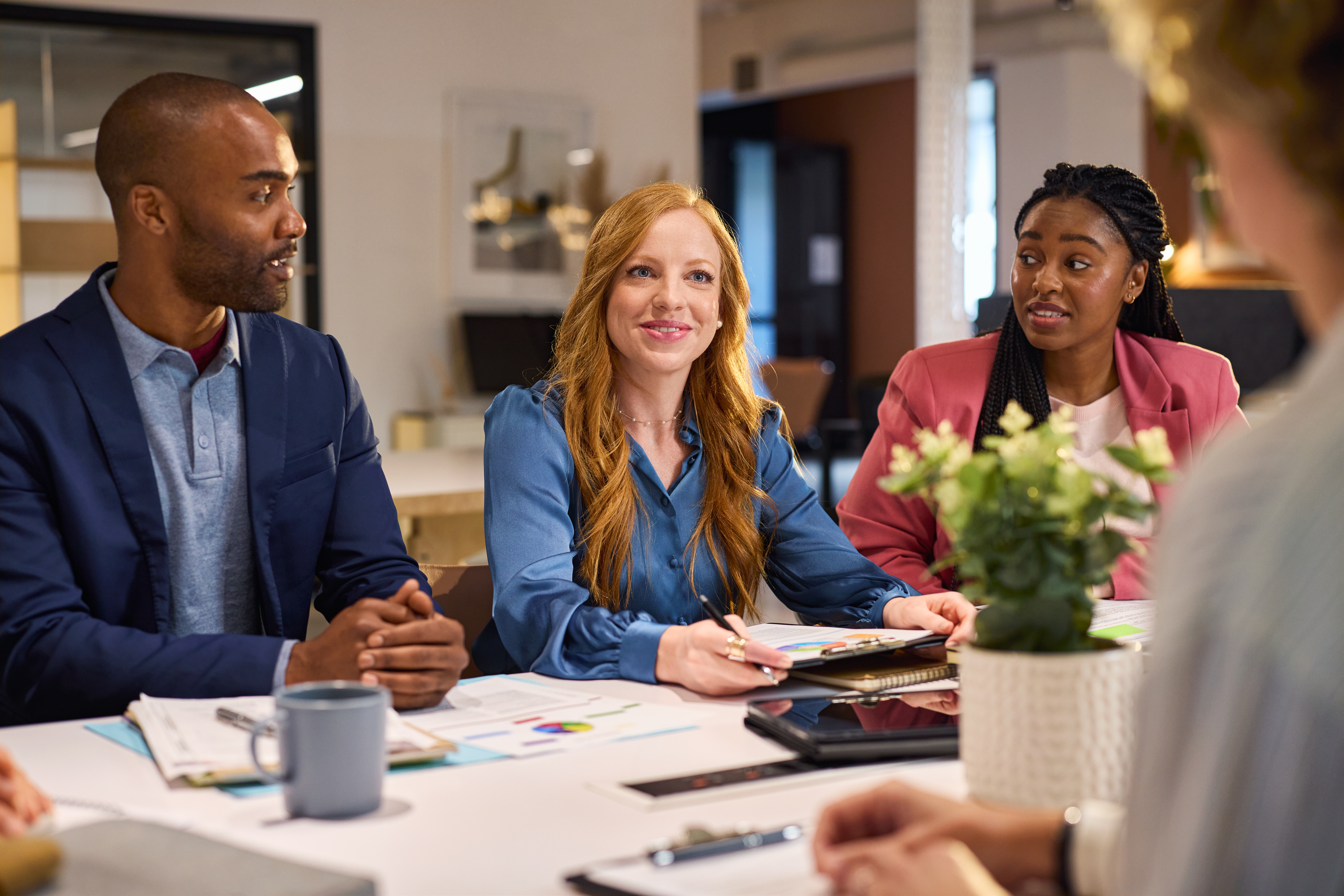 Engaged coworkers planning career advancement strategies during a productive office discussion.